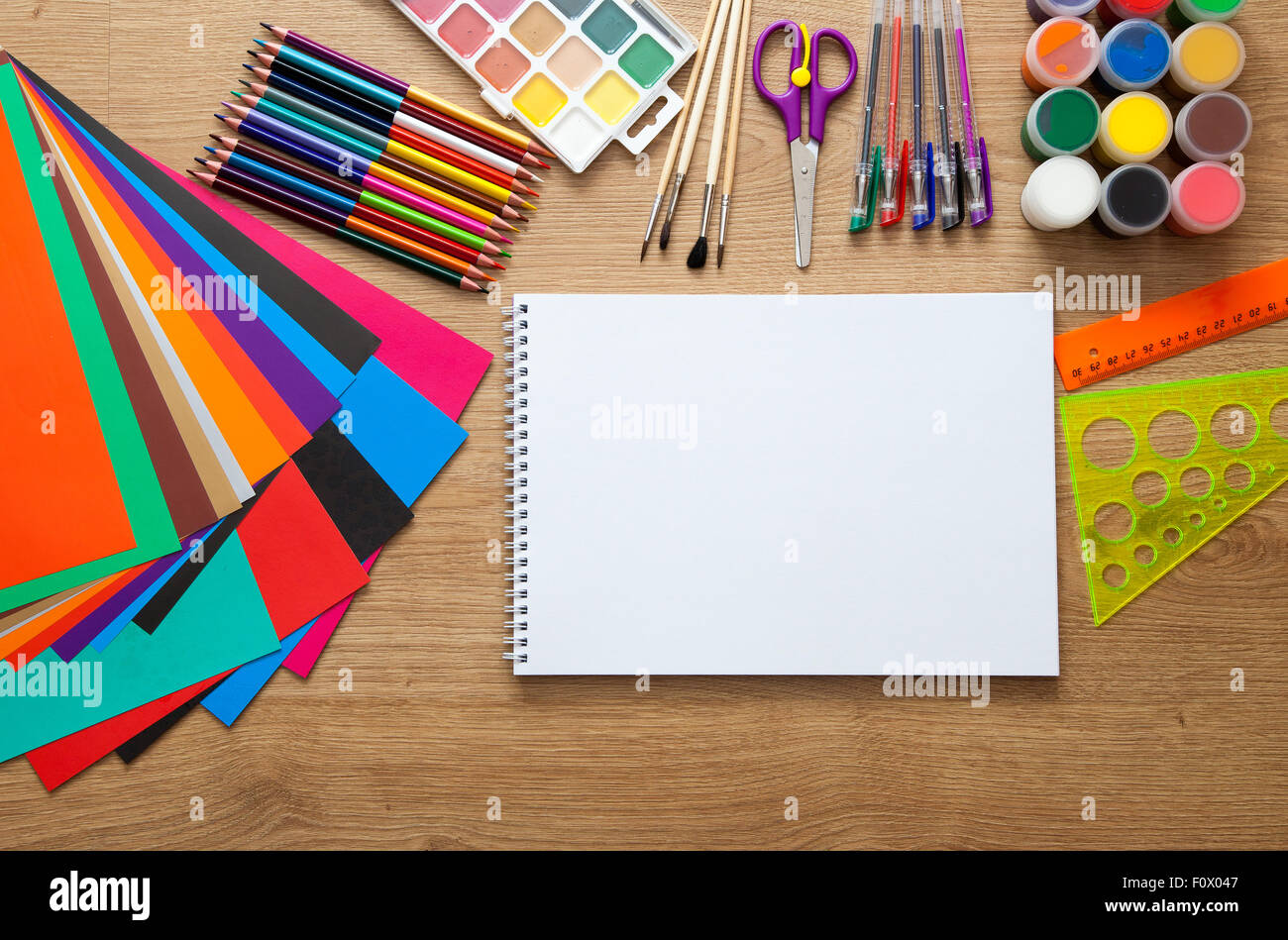 set of school supplies with pencil, colored pen, watercolor paint, notebook and scissors Stock Photo