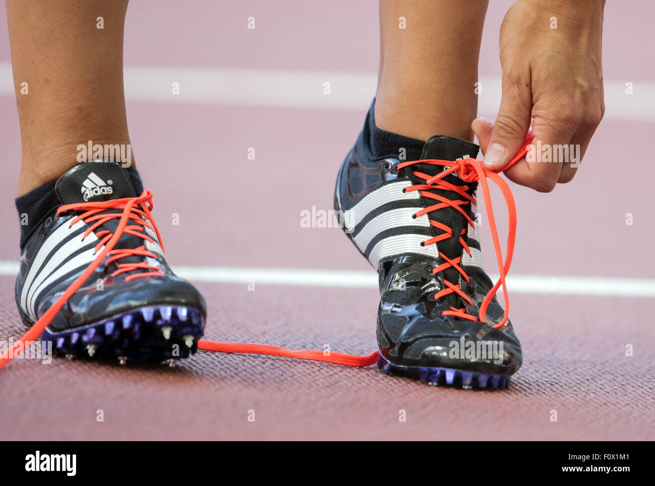 Beijing, China. 22nd Aug, 2015. Germany's Jennifer Oeser takes off her shoes after the 100 m hurdles segment of the heptathlon competition at the 15th International Association of Athletics Federations (IAAF) Athletics World Championships at the National stadium, known as Bird's Nest, in Beijing, China, 22 August 2015. Photo: Michael Kappeler/dpa/Alamy Live News Stock Photo