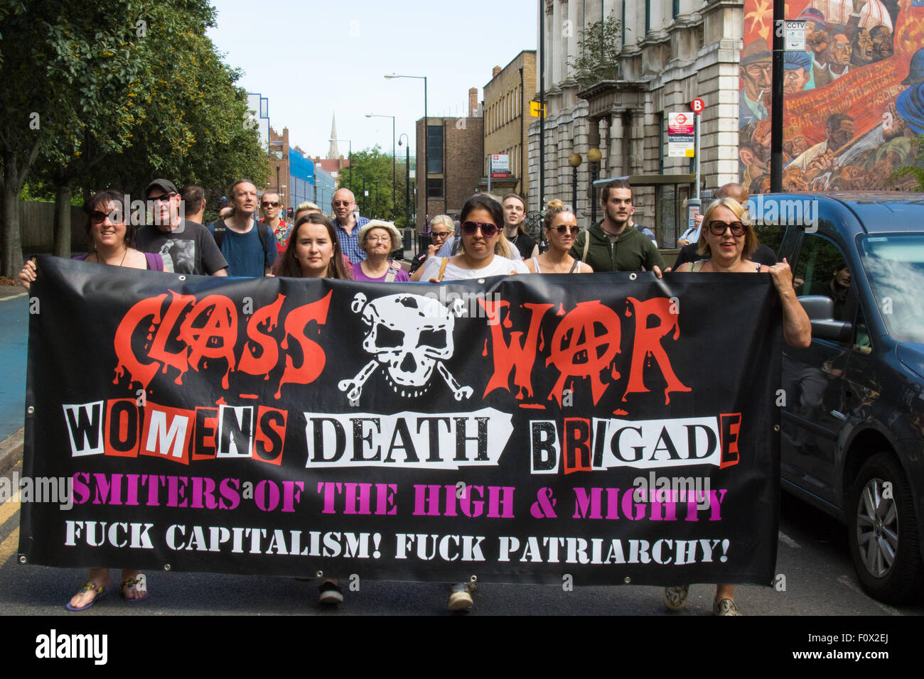 Cable Street, London, August 22nd 2015. Activists from Class War demonstrate against the newly established Jack The Ripper Museum on Cable Street, claiming that it demeans women by profiting off the death of prostitutes killed by the Ripper. The Museum, during its planning stage, claimed that it would be dedicated to the Suffragettes movement. Credit:  Paul Davey/Alamy Live News Stock Photo