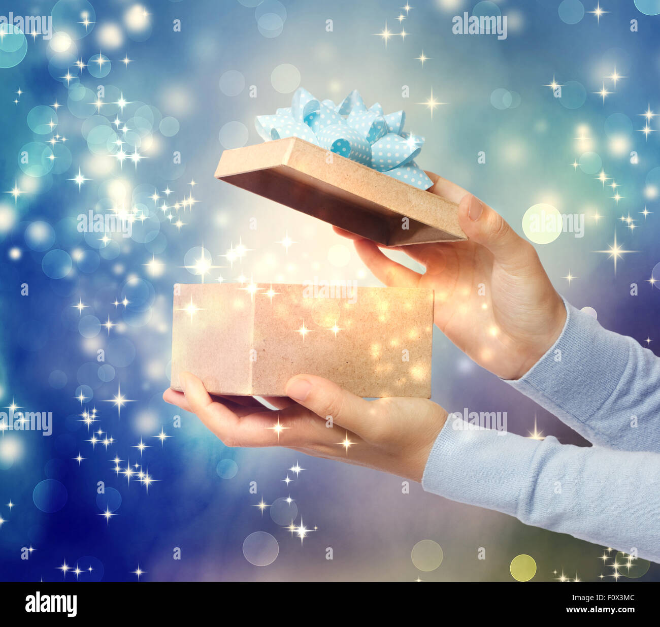 A magical glowing present box being opened Stock Photo