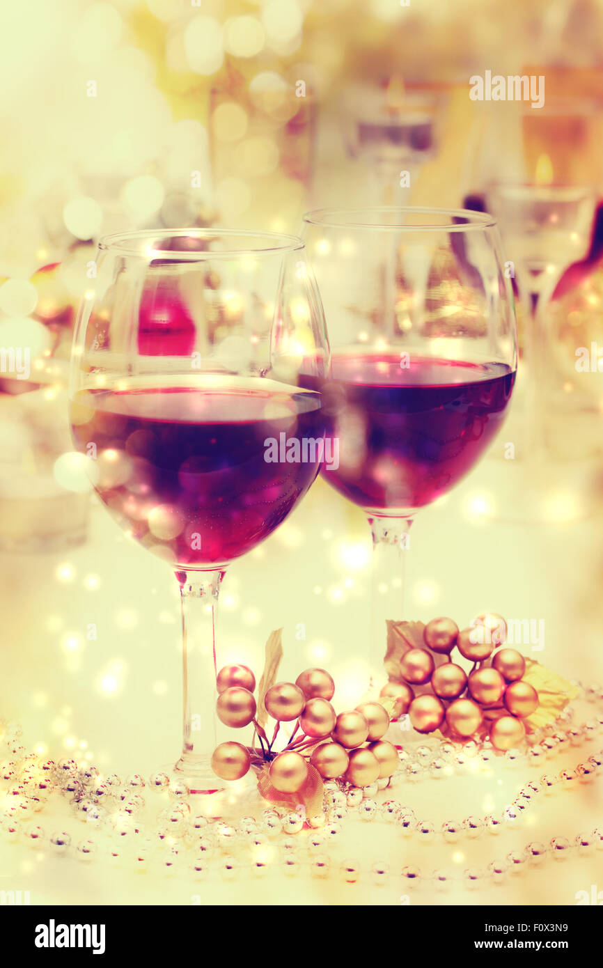 Holiday celebration red wine glasses with festive dinner table setting Stock Photo