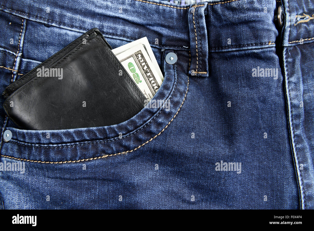 Wallet with dollars in the pocket of jeans Stock Photo