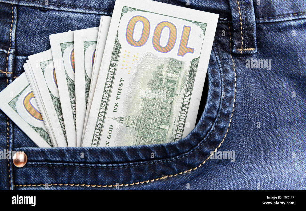 100 dollar bills money in pocket of blue jeans Stock Photo