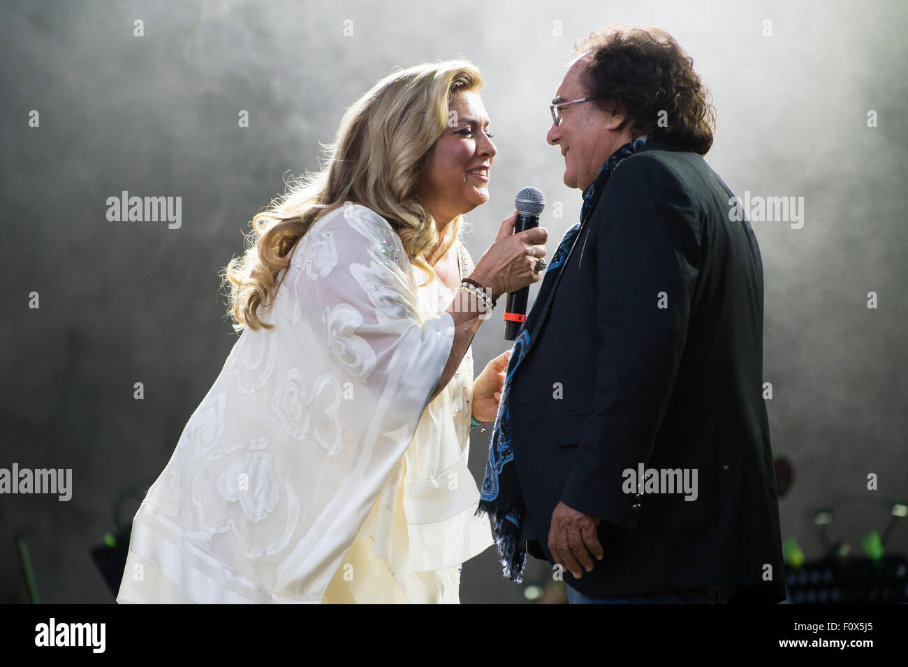 Berlin, Germany. 21st Aug, 2015. Singing duo Romina Power and Albano Carrisi (Al Bano) perform on stage during a concert in Berlin, Germany, 21 August 2015. The concert is their first in the German-speaking region in 20 years. Photo: Gregor Fischer/dpa/Alamy Live News Stock Photo