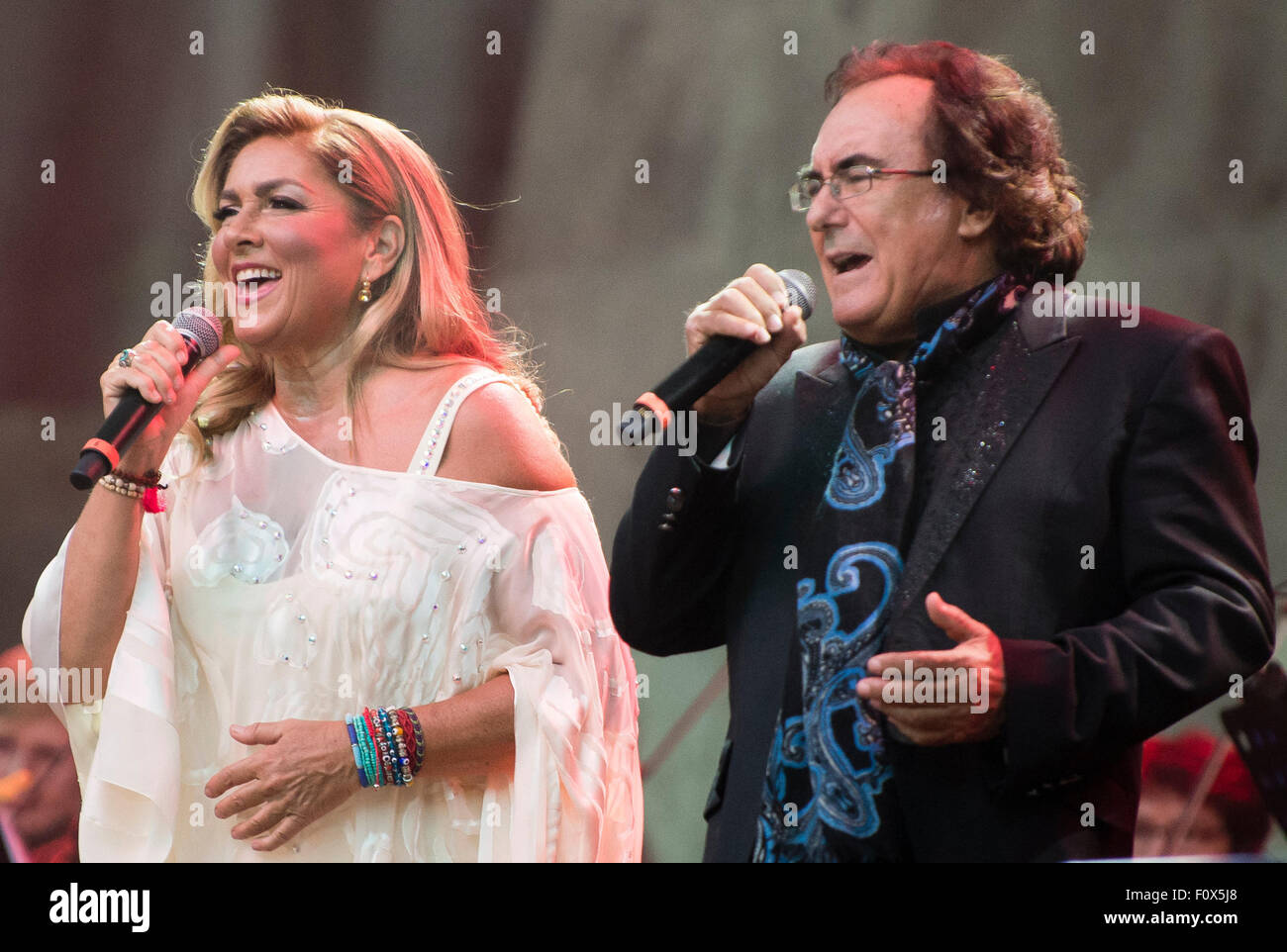 Berlin, Germany. 21st Aug, 2015. Singing duo Romina Power and Albano Carrisi (Al Bano) perform on stage during a concert in Berlin, Germany, 21 August 2015. The concert was their first in the German-speaking region in 20 years. Photo: Gregor Fischer/dpa/Alamy Live News Stock Photo