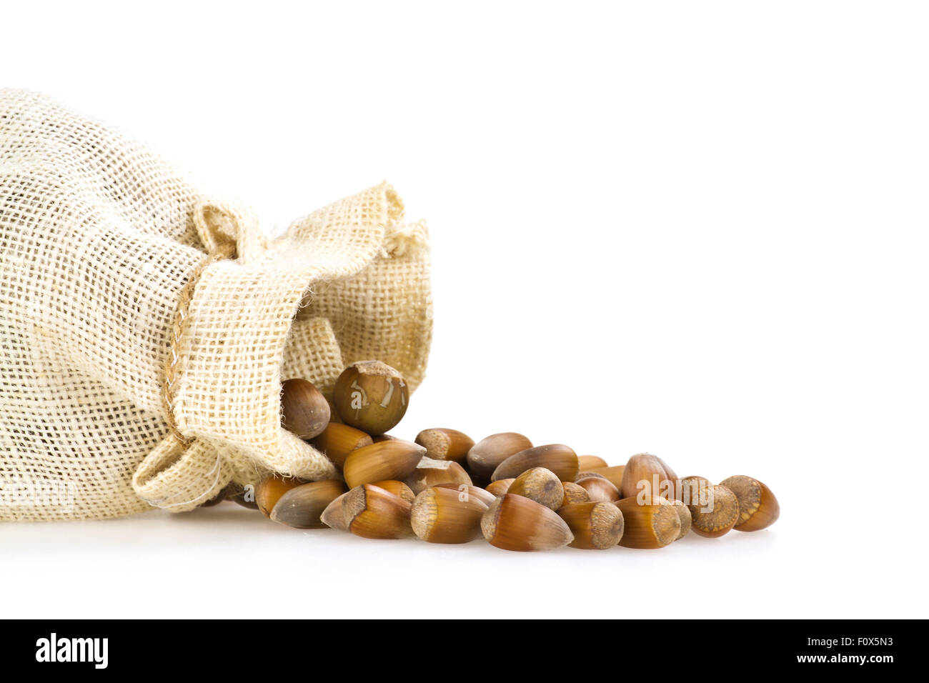 Hemp bag with scattered hazelnuts in shell Stock Photo