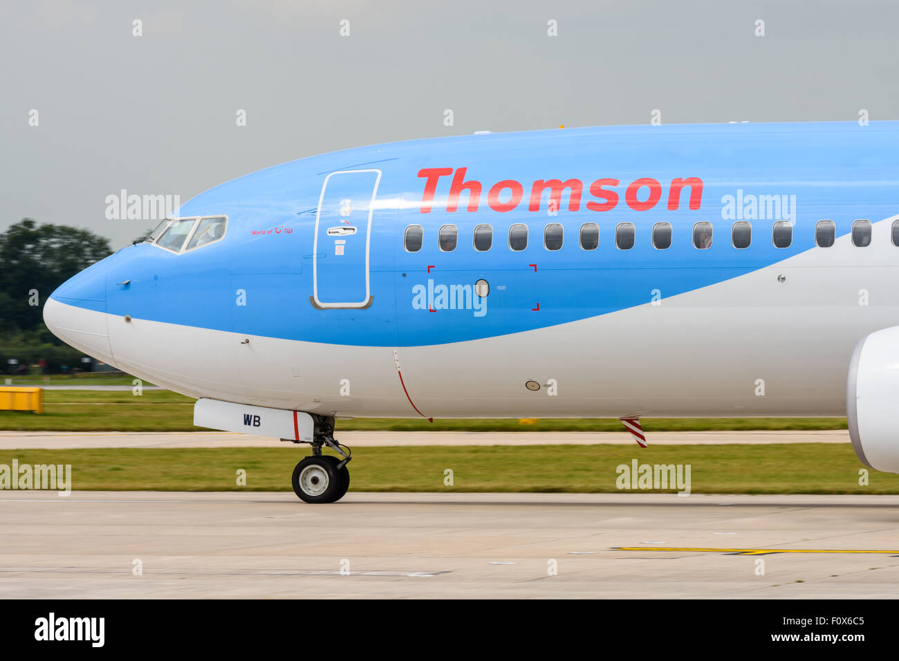 Side view of the front of a Thomson Boeing 737-800 aeroplane waiting to take off at Manchester Airport Stock Photo