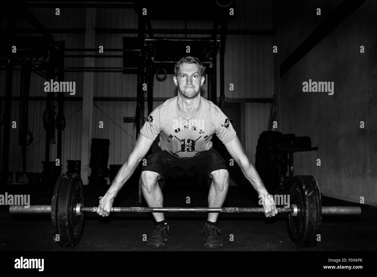 A male crossfit athlete at the beginning position of a snatch Stock Photo