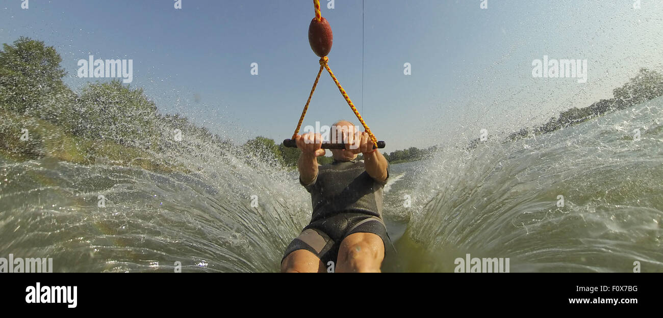 Water Ski Ride Suesel, Germany. 22nd Aug, 2015. A water skier rides along a water ski ...