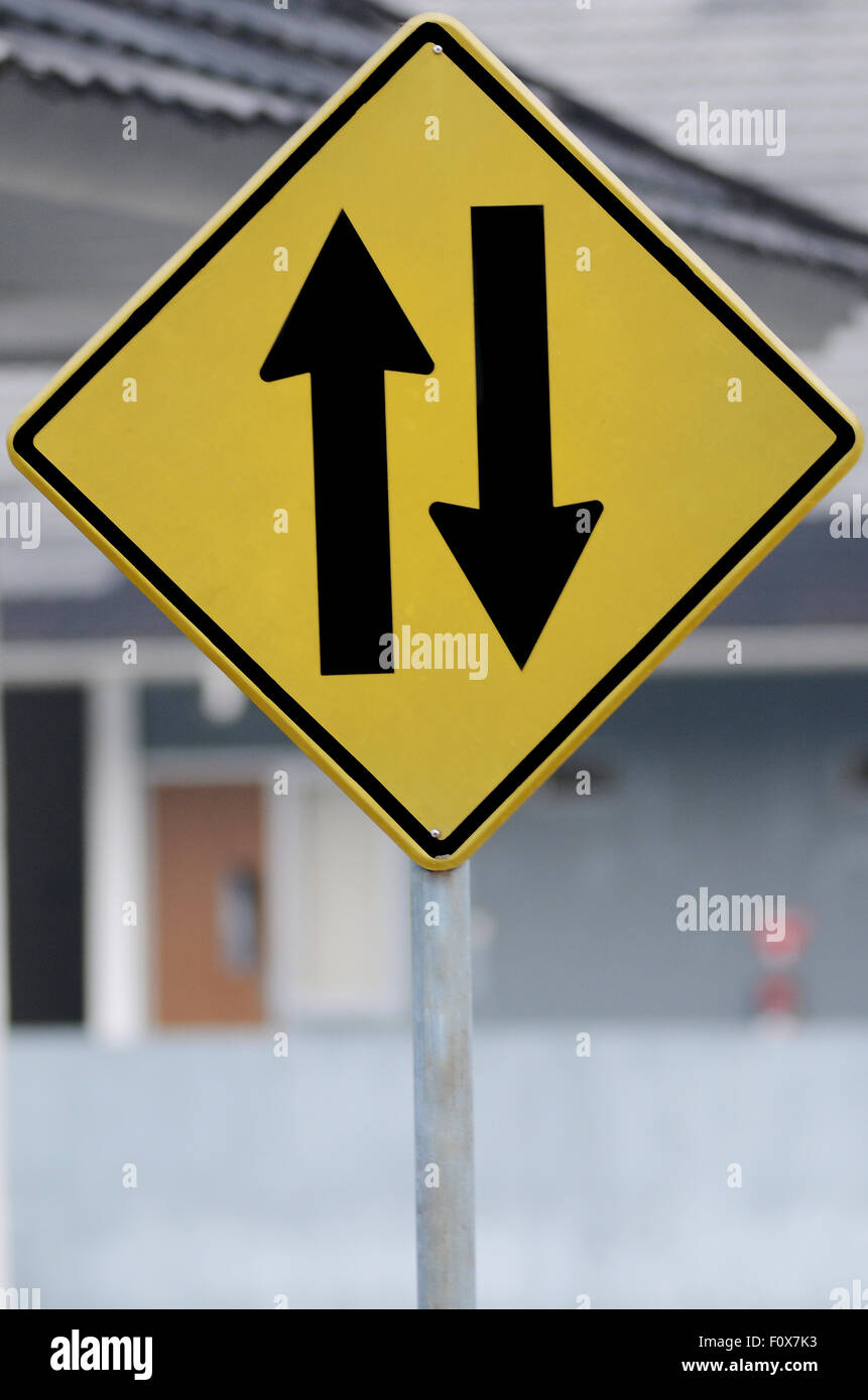 road sign Two way traffic ahead, watch for oncoming traffic ahead Stock Photo