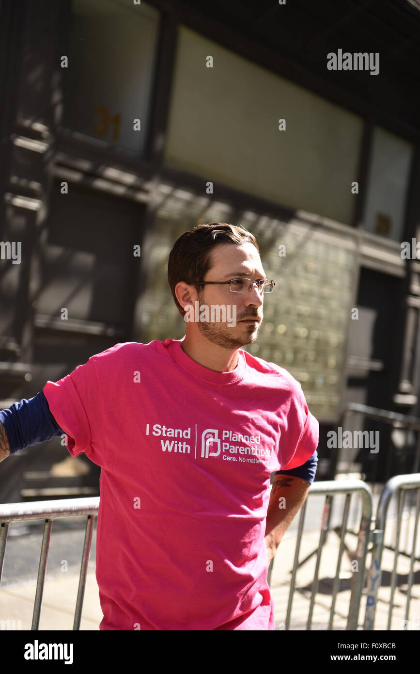 New York City, United States. 22nd Aug, 2015. Counter-protester with Planned Parenthood shirt across Bleecker Street from antiabortion protest. A coalition of anti-abortion protesters protested on Mott Street in Manhattan in front of Planned Parenthood. Credit:  Andy Katz/Pacific Press/Alamy Live News Stock Photo