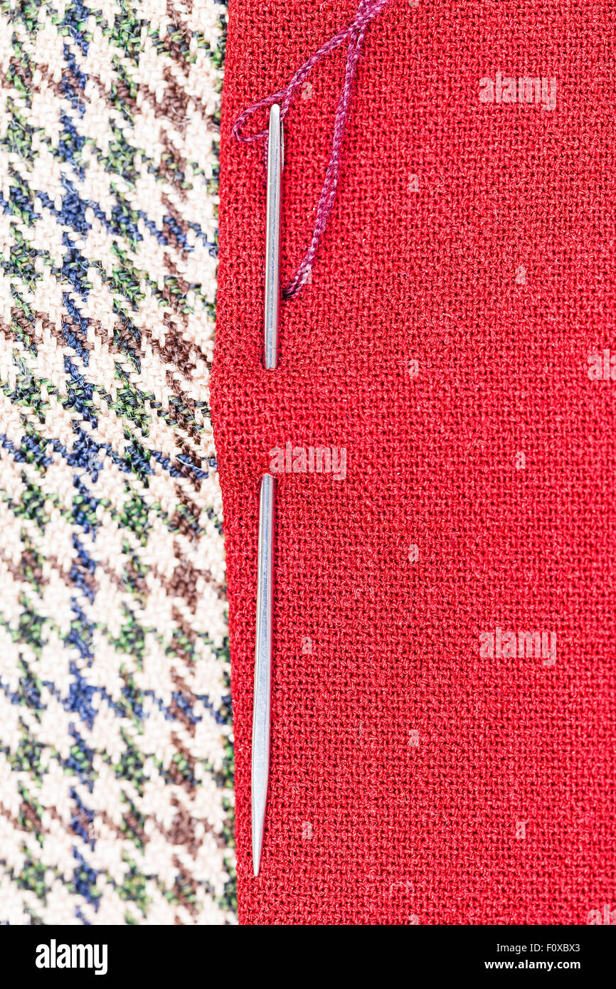 needle sews two pieces of fabric close up Stock Photo - Alamy