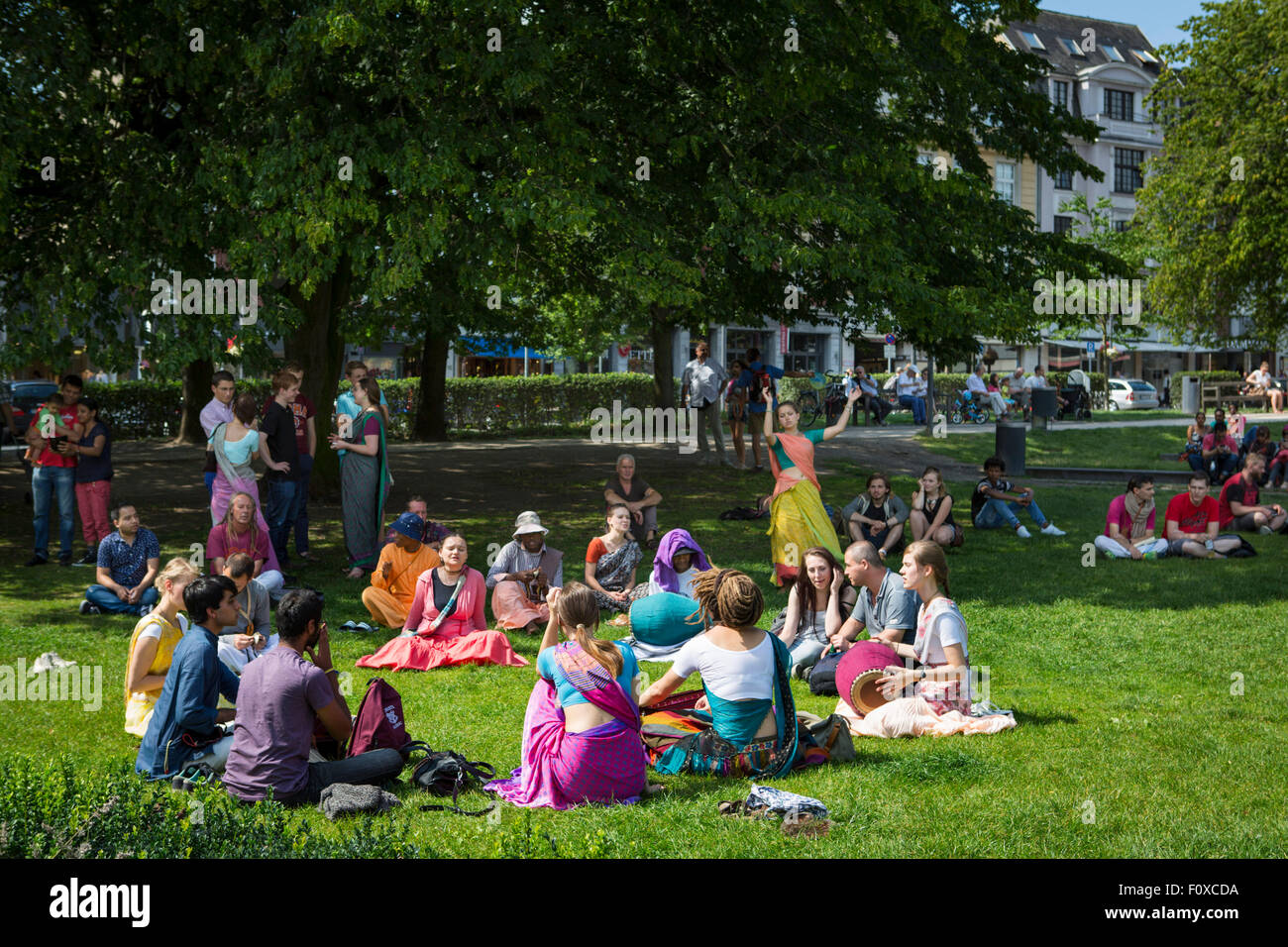 Hare Krishna people singing and dancing in the park in Aachen, Germany Stock Photo