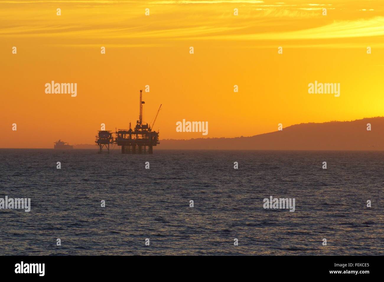 California coast oil rig platform off-shore drilling at sunset Stock ...