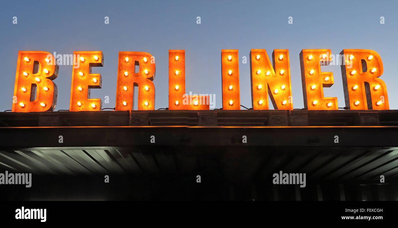 Berliner sign in lights with sky behind, bar serving bier Stock Photo