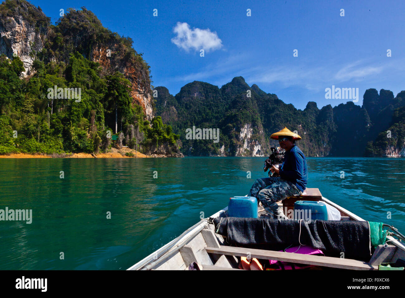 KARST FORMATIONS covered with tropical jungle surround CHEOW EN LAKE in KHAO SOK NATIONAL PARK - THAILAND Stock Photo