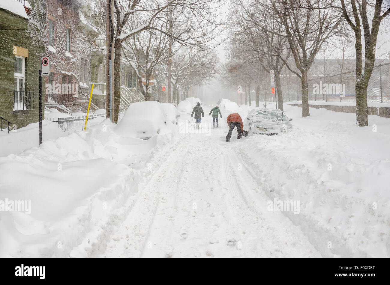 People digging with spades clearing snow in a Montreal street, after a ...