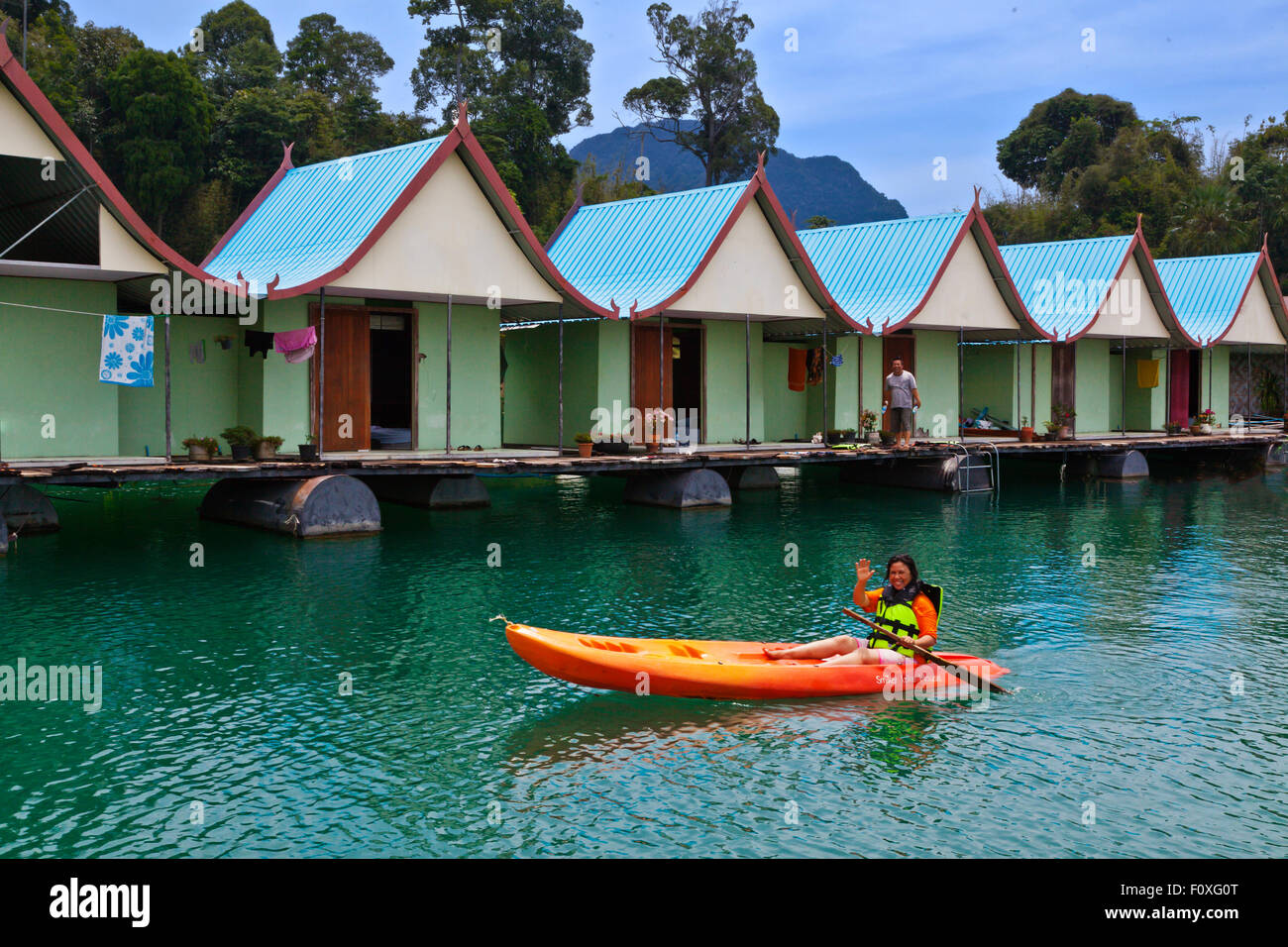 KAYAKING at SMILEYS FLOATING BUNGALOWS which provides mid-range accommodations on CHEOW EN LAKE in KHAO SOK NATIONAL PARK - THAI Stock Photo