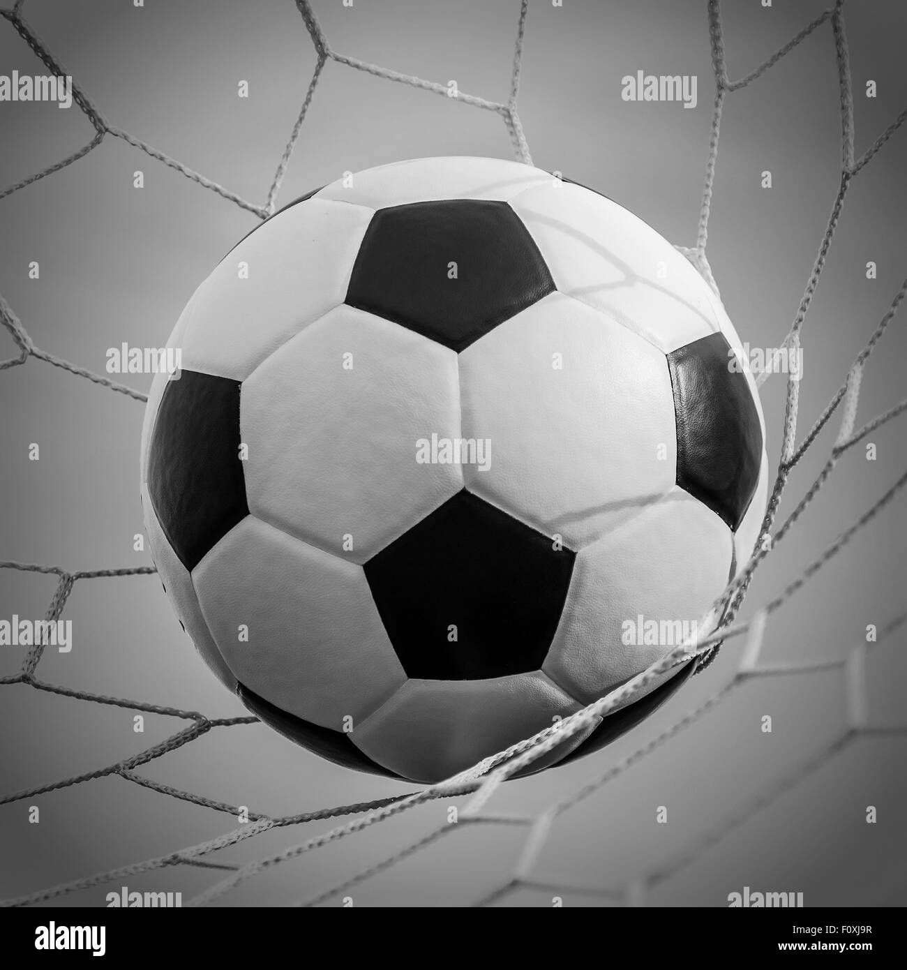 Soccer football in Goal net with Sky field. For sport concept. Stock Photo