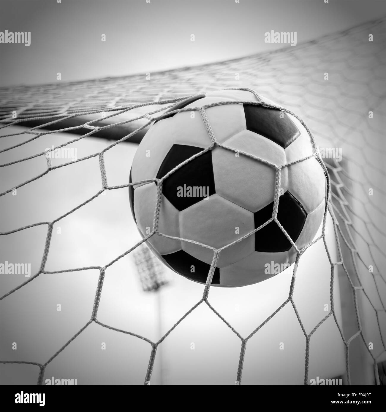 Soccer football in Goal net with Sky field. For sport concept Stock