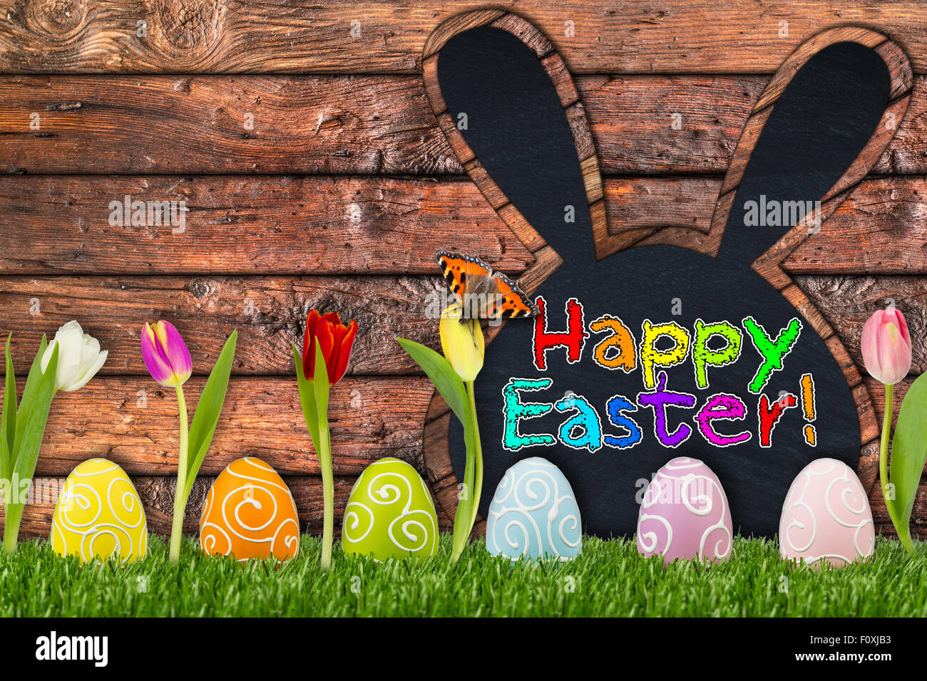 easter eggs and tulips in front of wooden background Stock Photo - Alamy