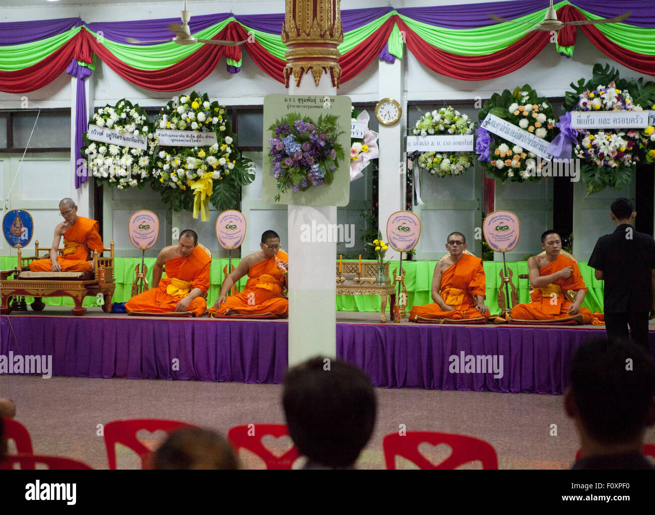 Monks chant during funeral services  for Yutnarong Singro at Wat Bangna Nok in Bangkok Thailand.  Three days after a bomb exploded killing him close to the Erawan shrine in central Chidlom district. At least 20 people died and 125 were injured in the attack. Stock Photo
