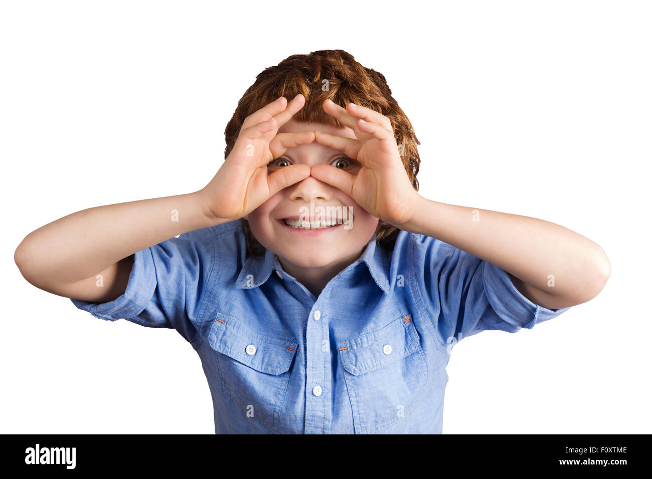 Handsome smiling boy makes aviator glasses with his hands. Isolated on