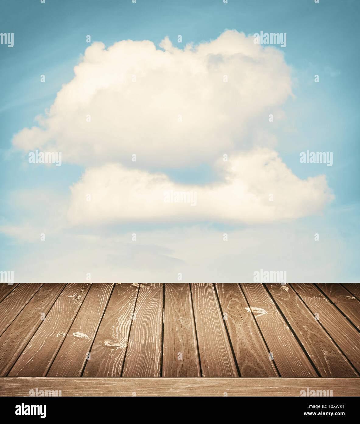 Sunny sky with clouds and wooden floor background Stock Photo