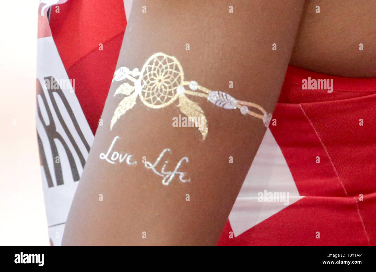 Beijing, China. 22nd Aug, 2015. A skin painting that reads 'Love Life' is seen on the arm of Erica Bougard of the US in the high jump section of the Heptathlon competition during the 15th International Association of Athletics Federations (IAAF) Athletics World Championships in Beijing, China, 22 August 2015. Photo: Michael Kappeler/dpa/Alamy Live News Stock Photo