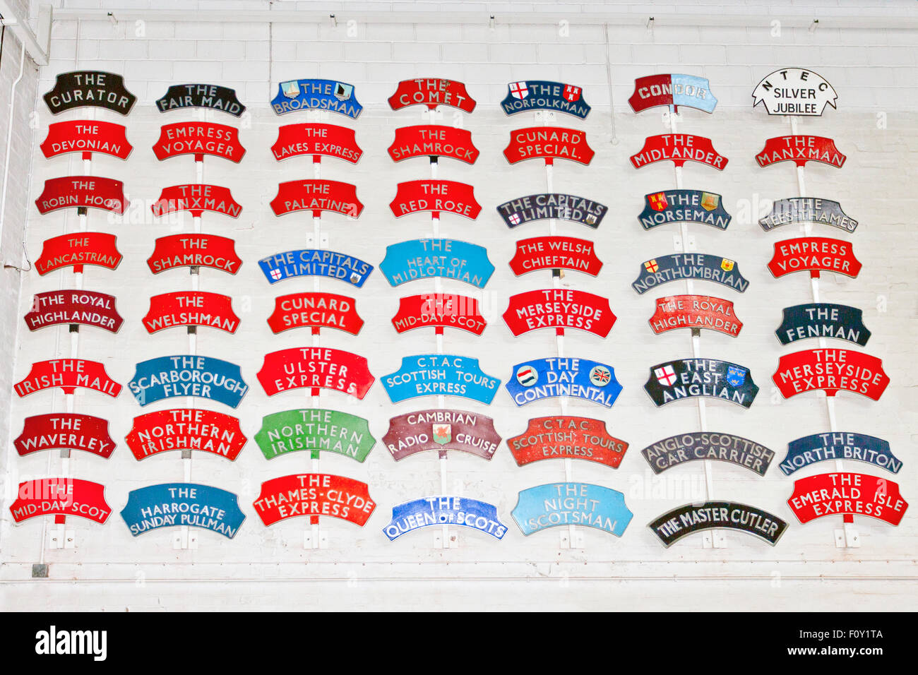 A colourful collection of passenger train headboards in the National