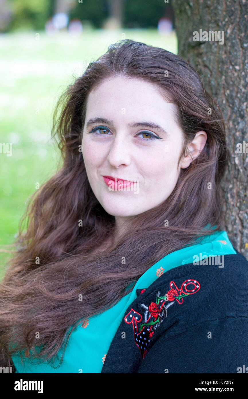 Headshot of a young woman with unique hazel eyes, and curly brown hair ...
