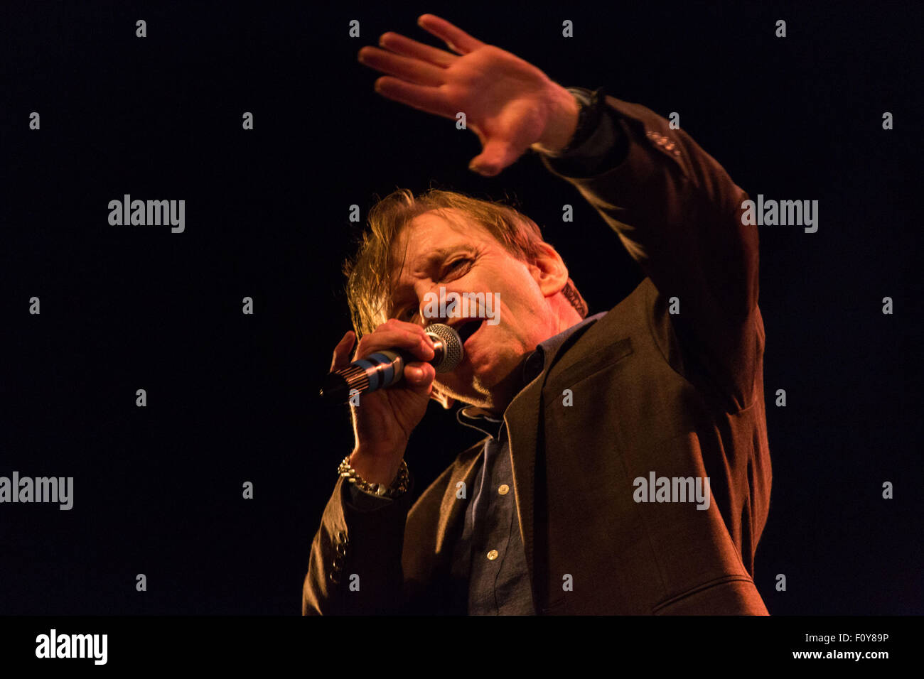 Glanusk Park near Brecon, Wales, 22nd August 2015. The second day of The Green Man music festival in the Brecon Beacons Mountains in Wales. The crowds experienced 24C heat and huge rainstorms. Pictured: Punk legend MARK E SMITH of THE FALL play on the Far Out Stage. Credit: Rob Watkins/Alamy Live News Team Stock Photo