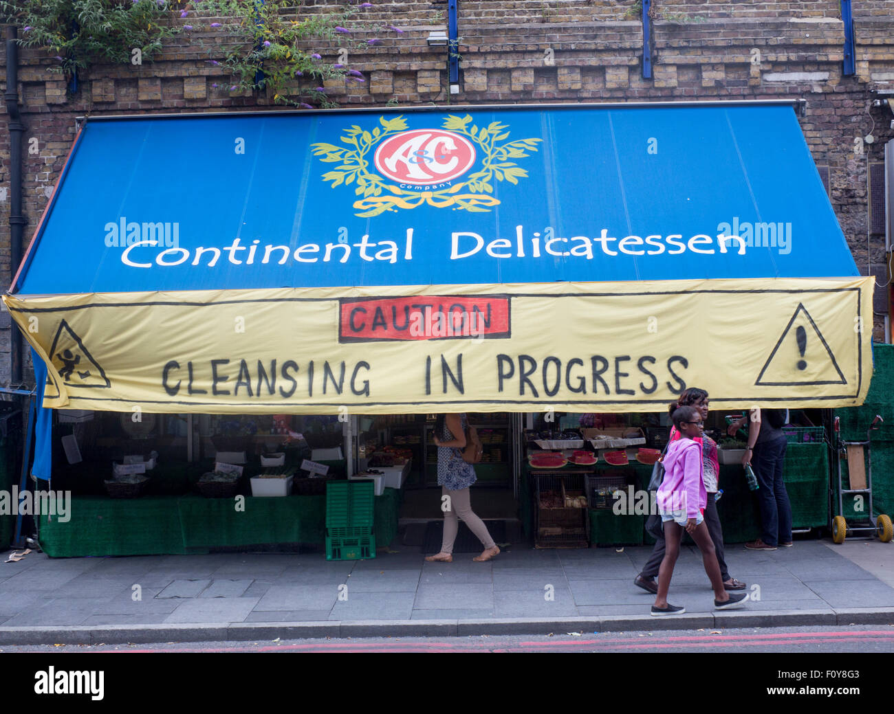 Social cleansing anti-gentrification protest banner outside food shop Brixton Arches Brixton London England UK Stock Photo