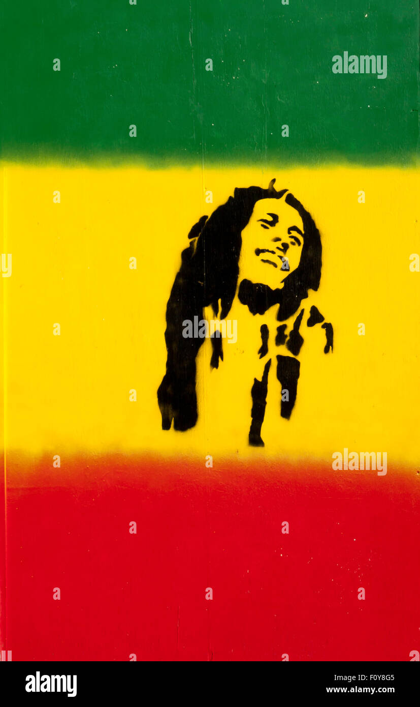 Stencil artwork of Bob Marley on red, yellow and green flag Cardiff South Wales UK Stock Photo