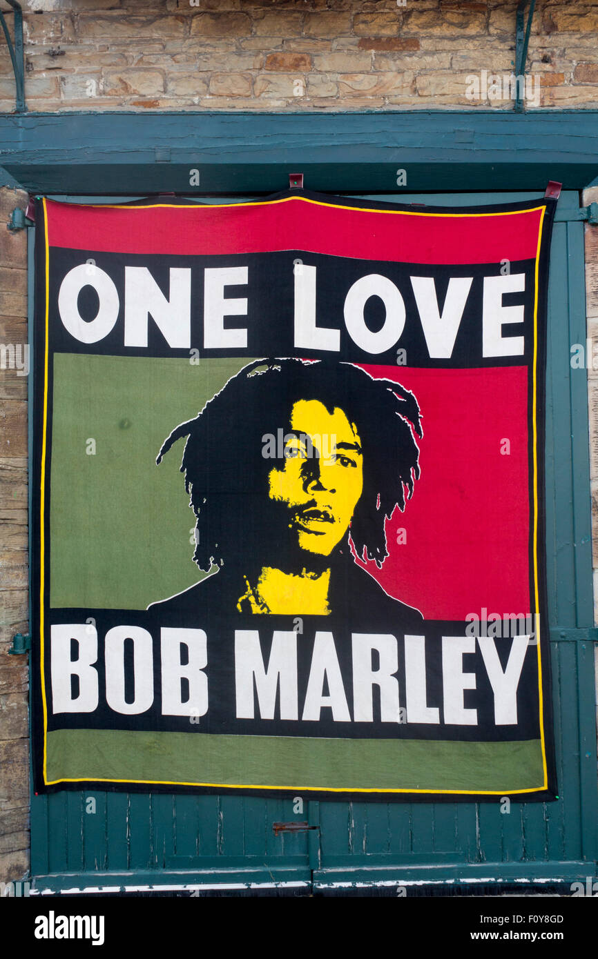 Bob Marley One Love banner poster art hanging on wall at festival Wales UK Stock Photo