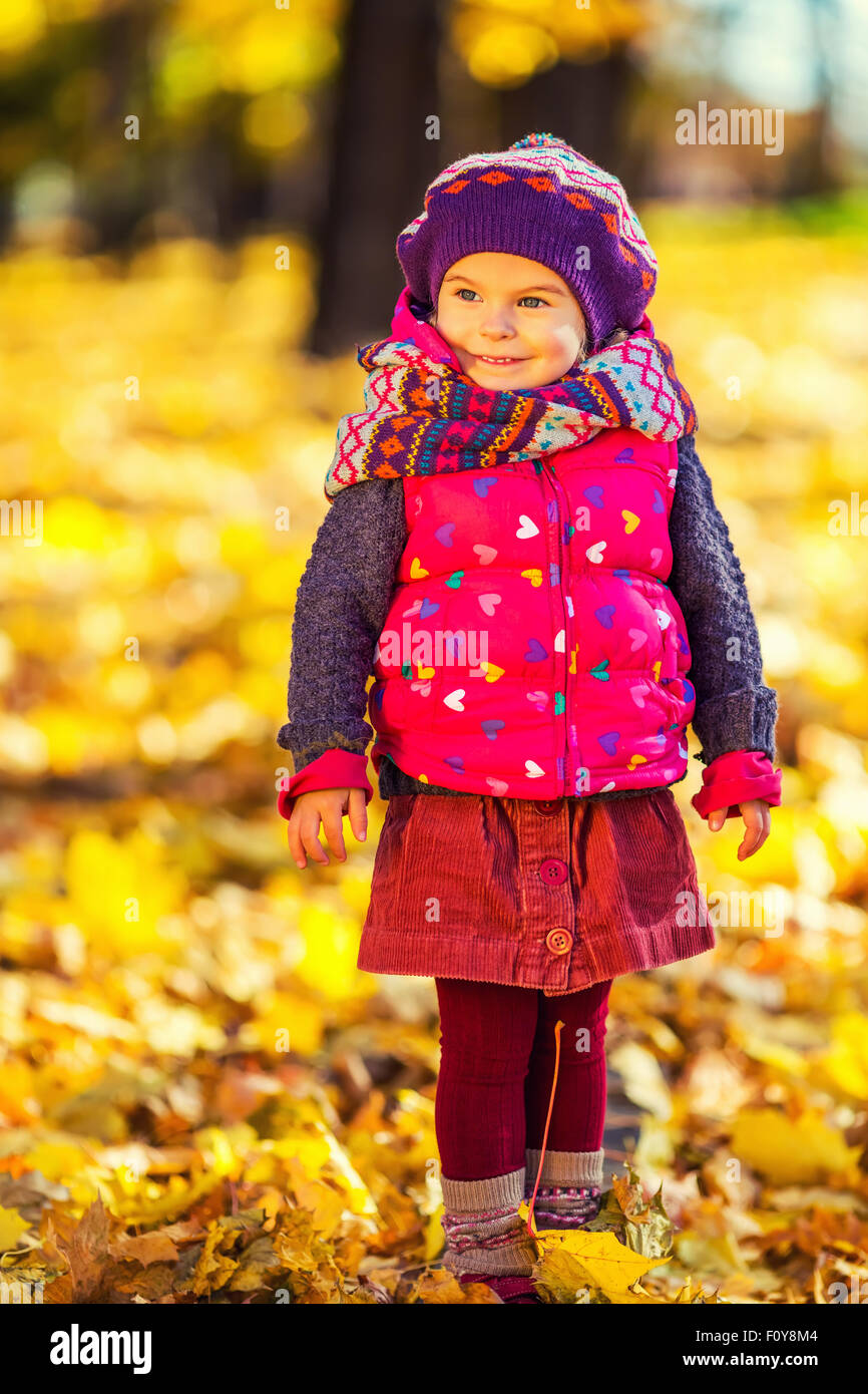 Cute little girl in the autumn park Stock Photo - Alamy