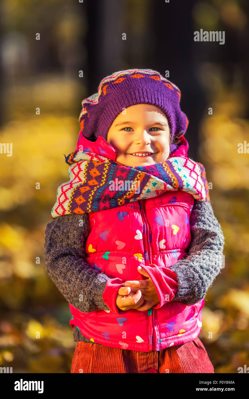 Cute little girl in the autumn park Stock Photo - Alamy