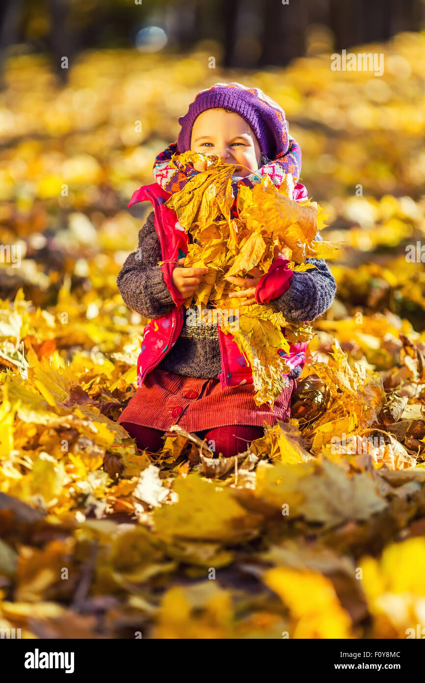 Little girl playing with autumn leaves Stock Photo - Alamy