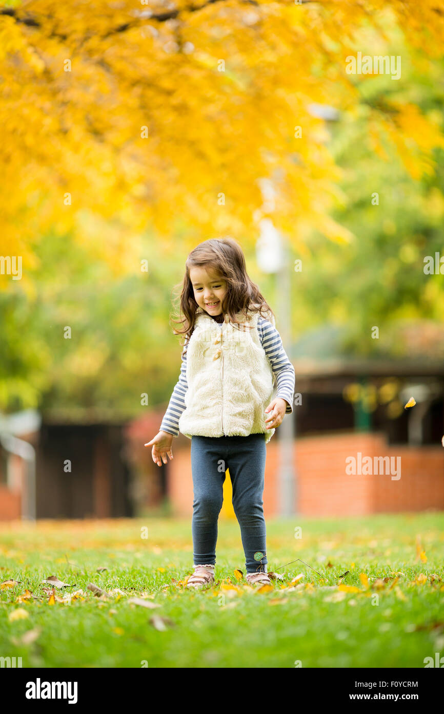 Little girl at the autumn park Stock Photo