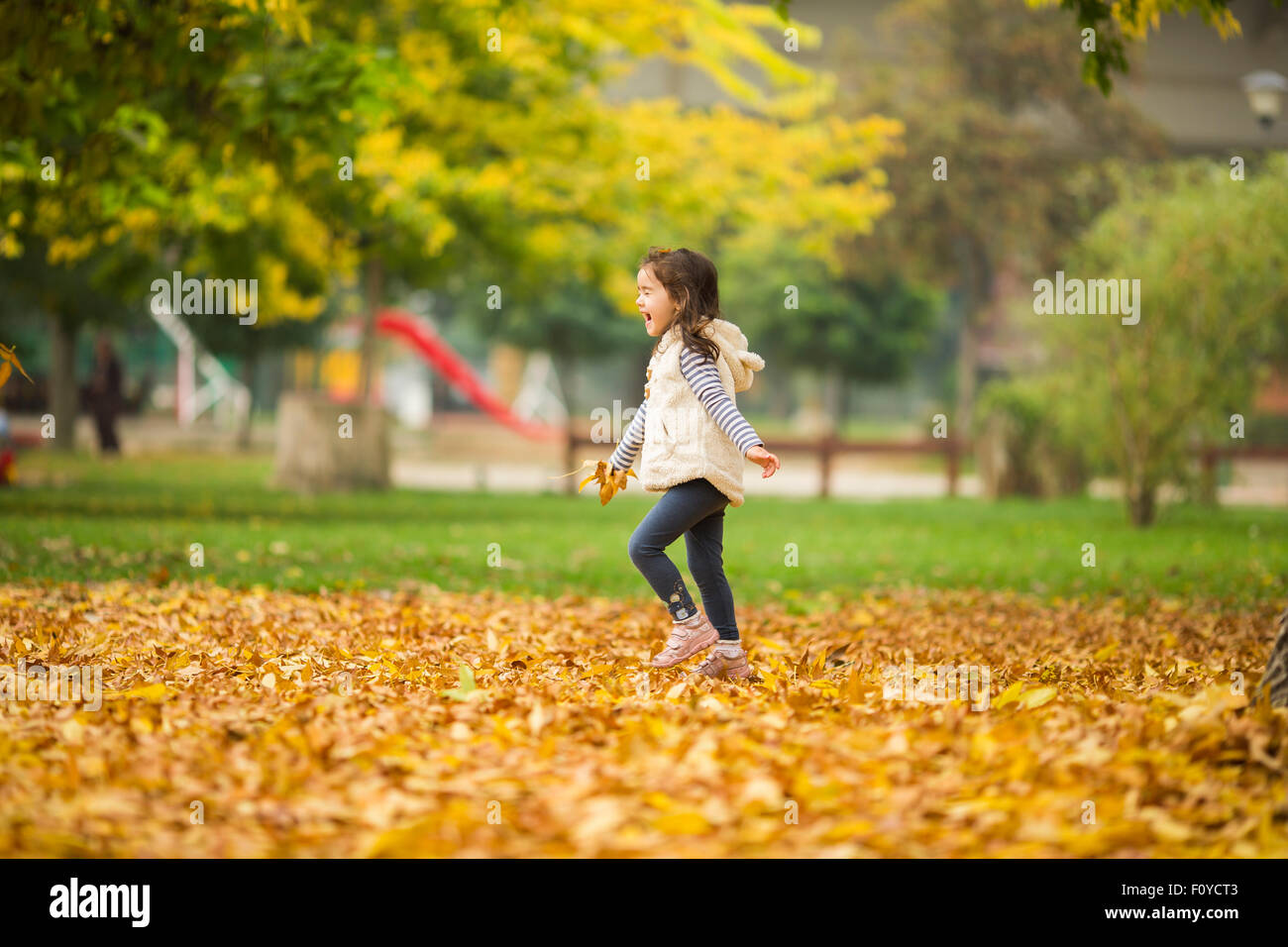 Little girl at the autumn park Stock Photo - Alamy