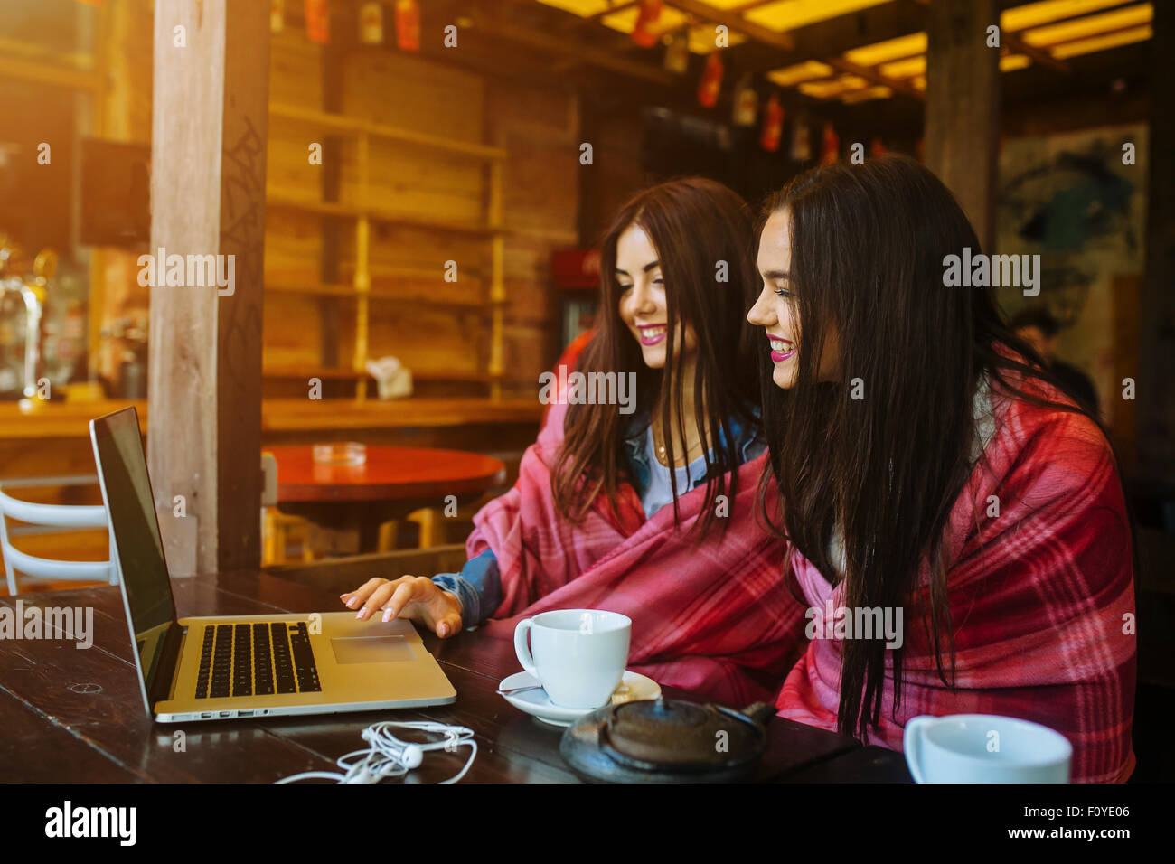 two girls watching something in laptop Stock Photo