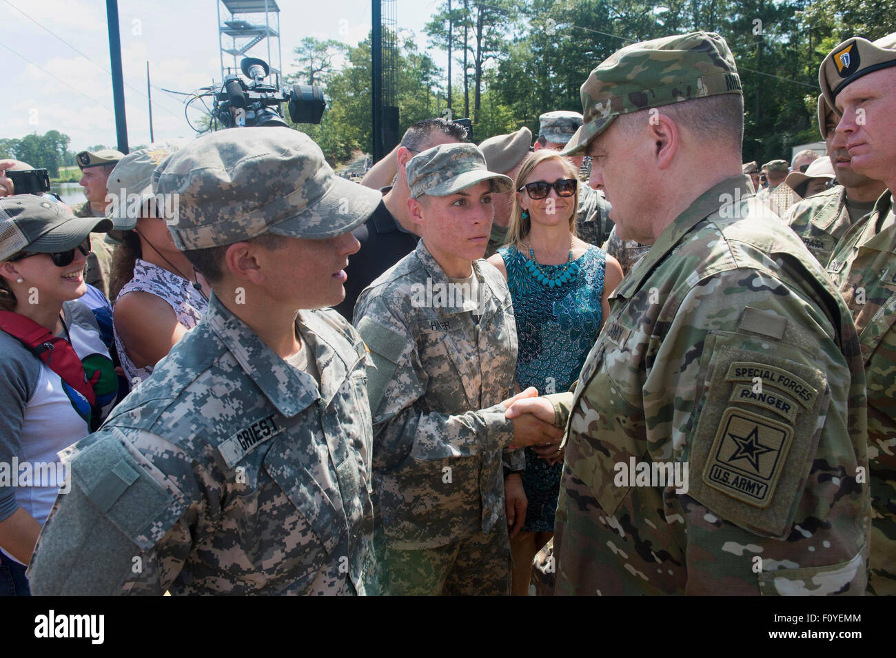 U.S. Army Captain Kristen Griest, left, and fellow soldier 1st Lt. Shaye Haver, center, are congratulated by Army Chief of Staff Gen. Mark A. Milley after they become the first women to graduate from Army Ranger school August 21, 2015 at Fort Benning, Georgia. Stock Photo