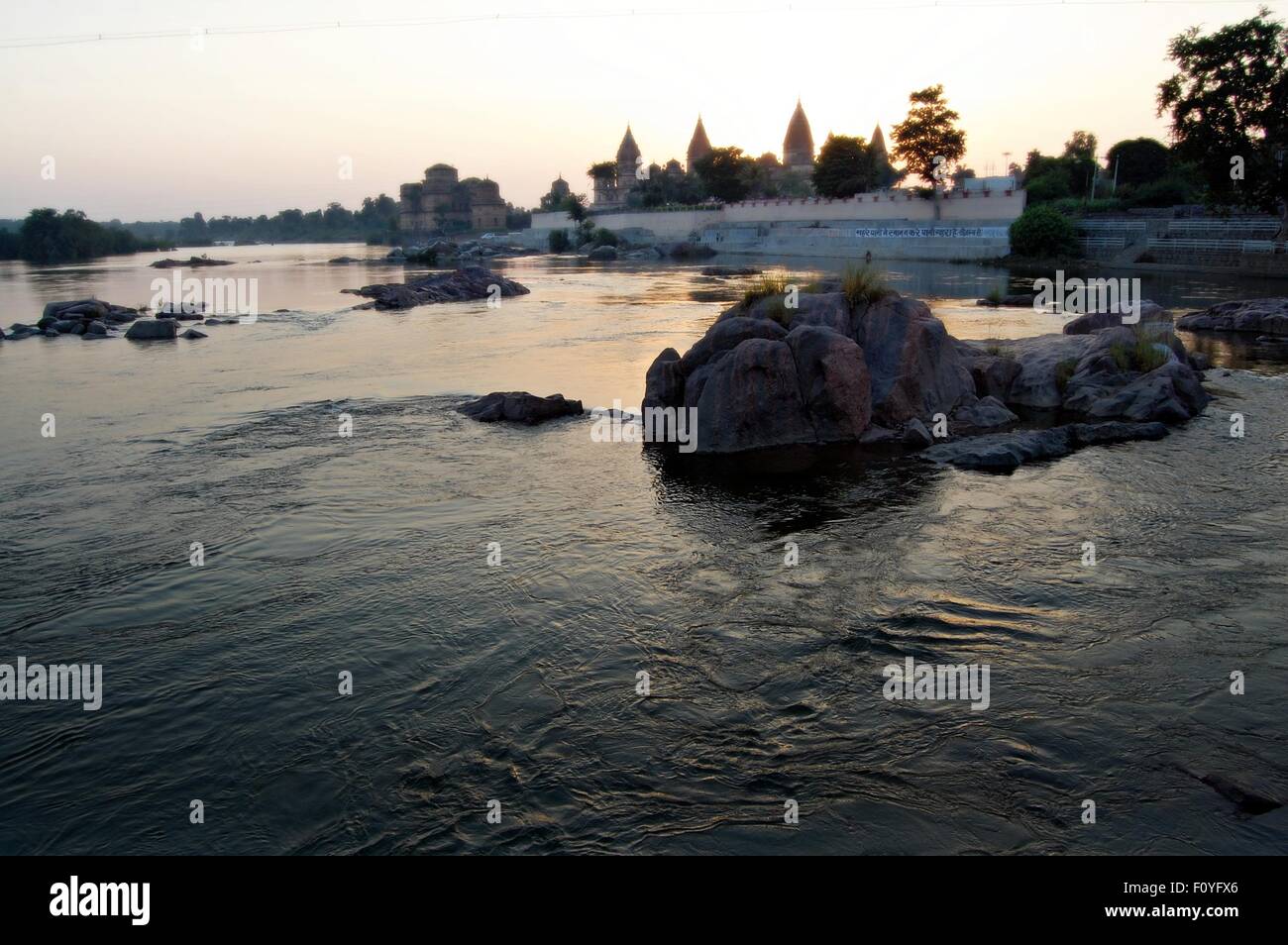 Chhatris line the River Betwa in Orchha village, Madhya Pradesh, Northern India in the Autumn evening light Stock Photo