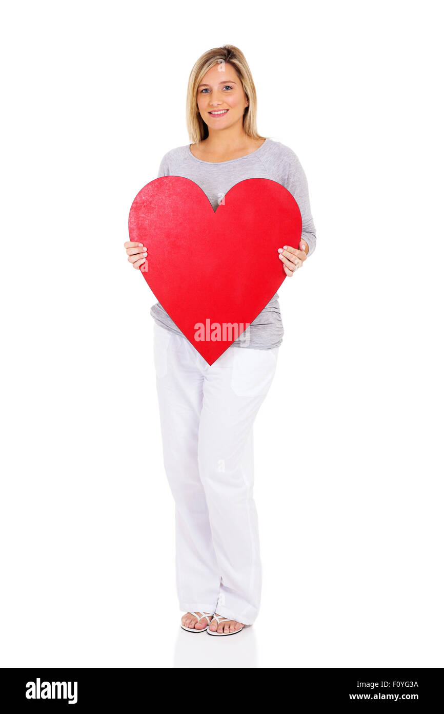 smiling young pregnant woman holding heart shape on white background Stock Photo