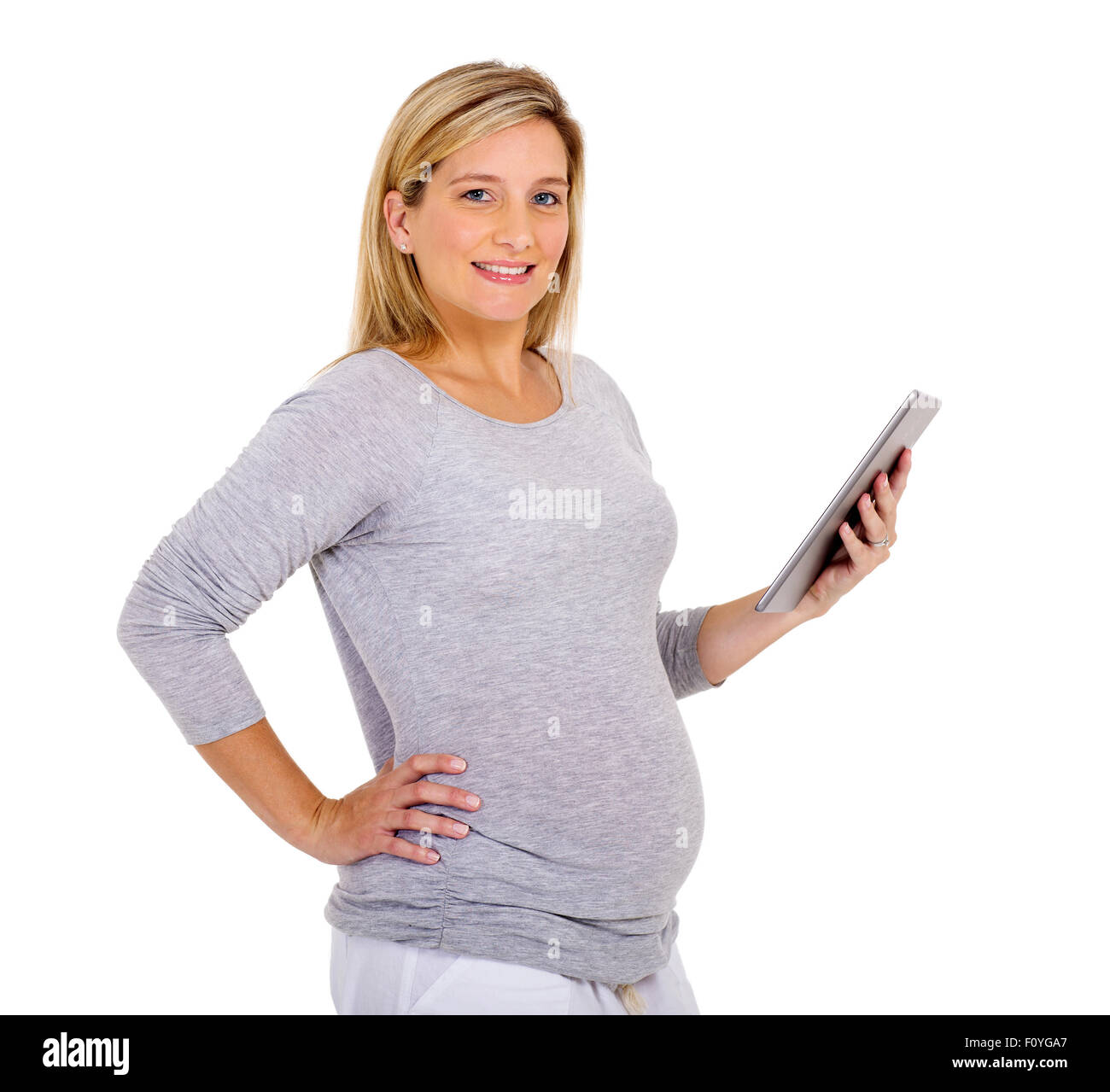 happy young pregnant woman holding tablet computer Stock Photo