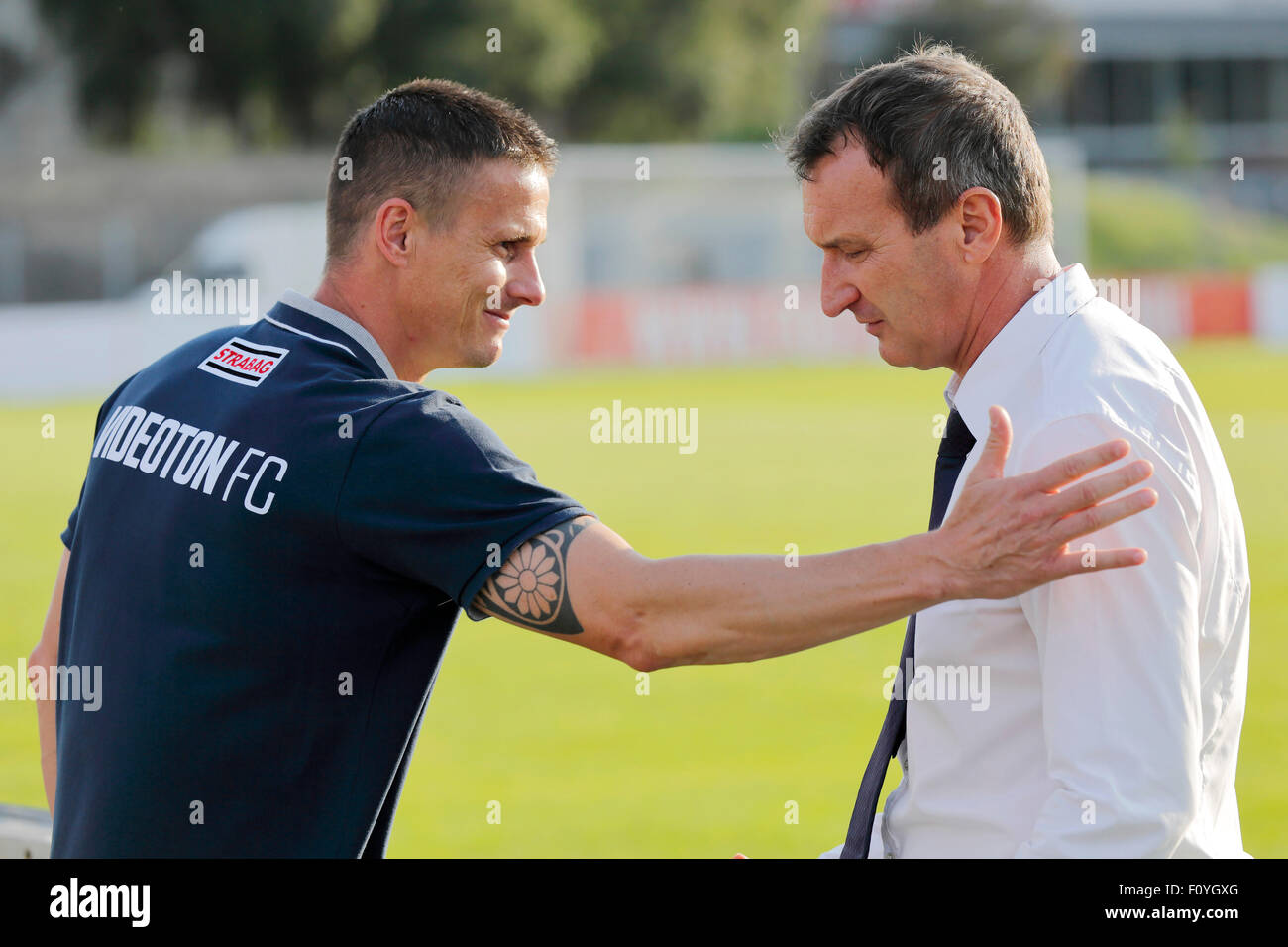 Budapest, Hungary. 23rd August, 2015. Manager of MTK, Csaba Laszlo (r) is greeted by temporary manager of Videoton, Tamas Peto during MTK vs. Videoton OTP Bank League football match in Illovszky Stadium. Credit:  Laszlo Szirtesi/Alamy Live News Stock Photo