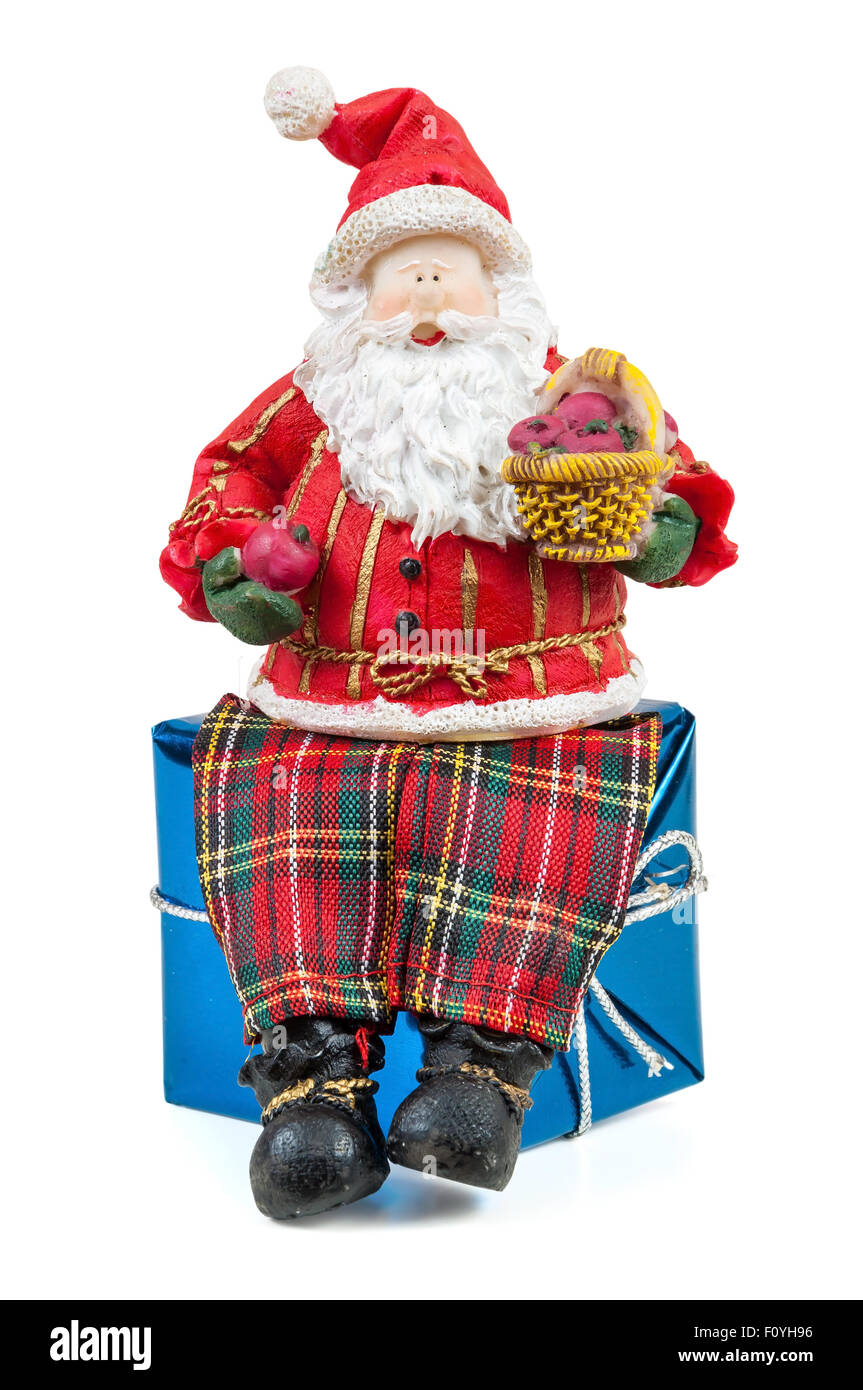 Santa Claus figure sitting on a gift box isolated on white background ...