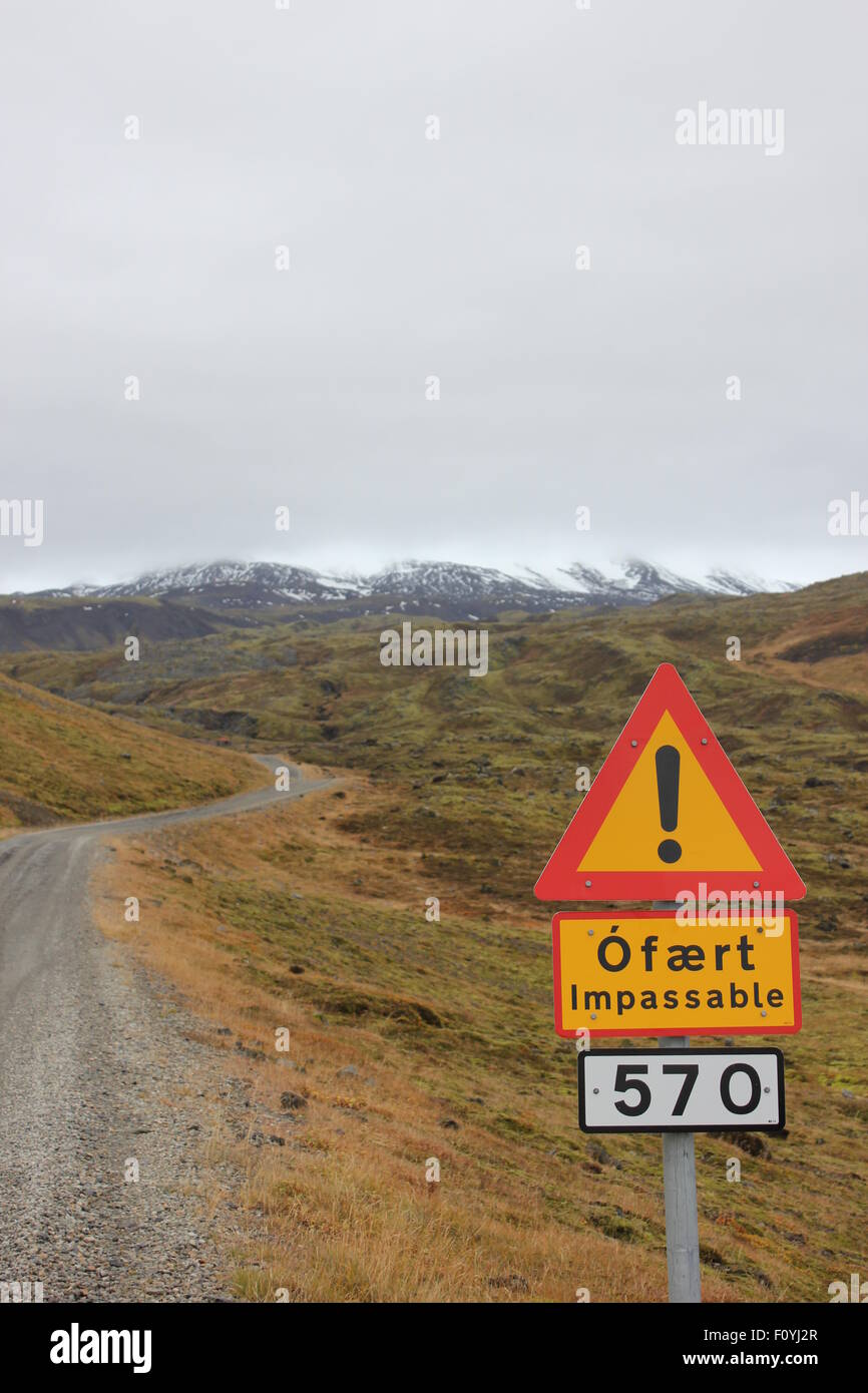 Hazard sign on rocky road into mountains, iceland Stock Photo