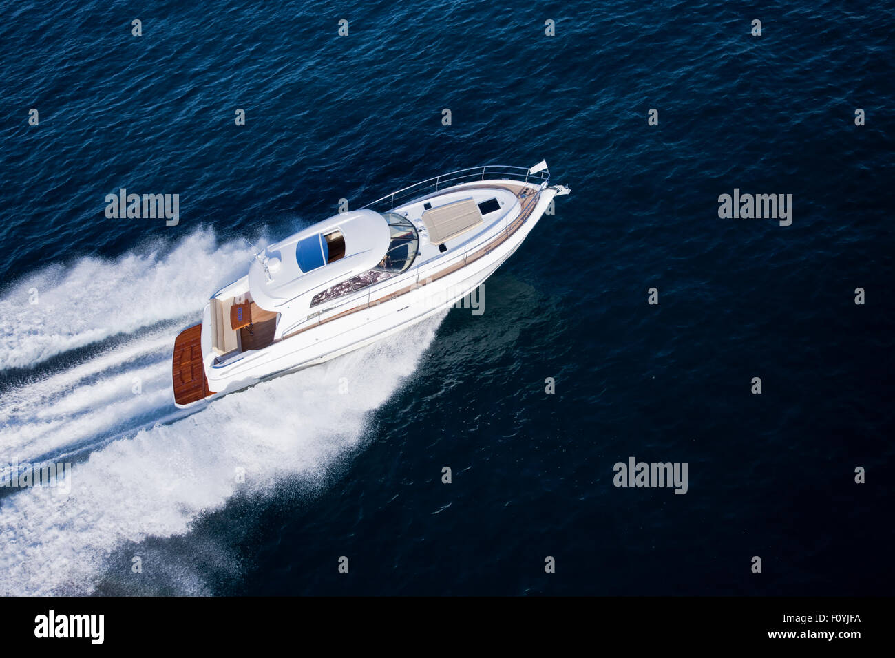 Image of a fast motor boat sailing though a deep blue ocean Stock Photo