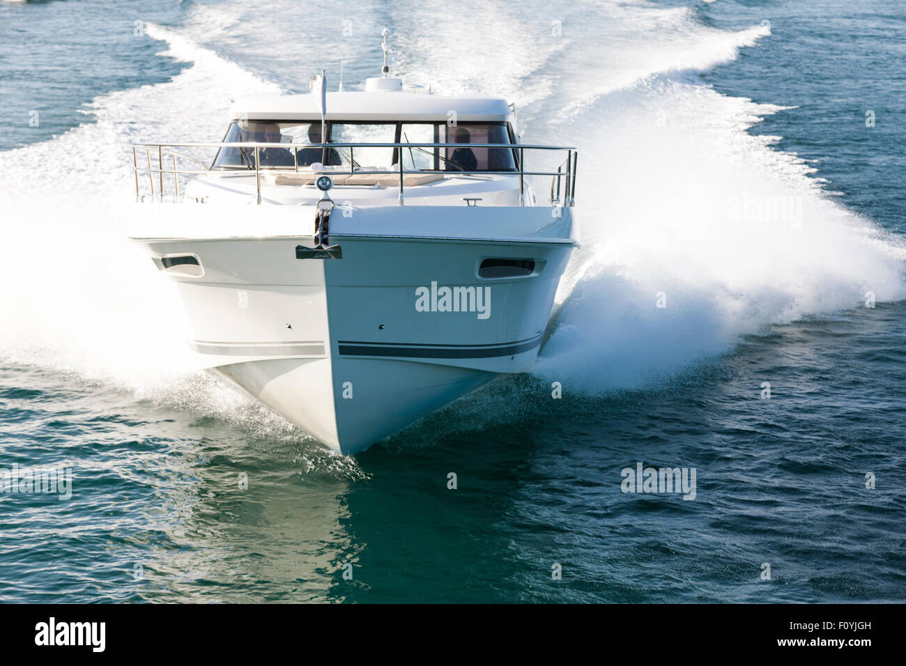 Image of a white motor boat approaching at high speed Stock Photo